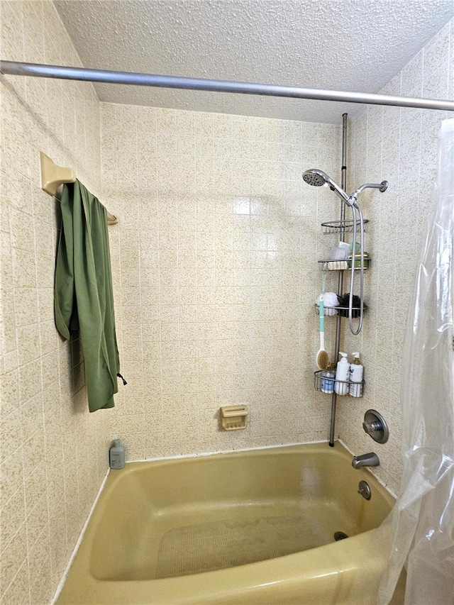 bathroom featuring shower / tub combo and a textured ceiling