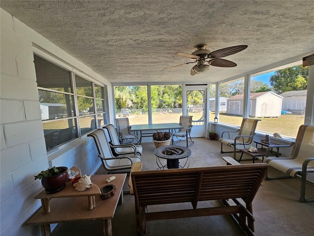 sunroom featuring ceiling fan