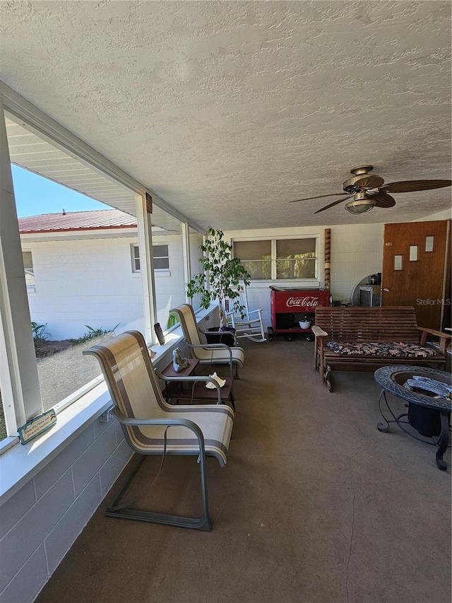 view of patio with ceiling fan and a balcony