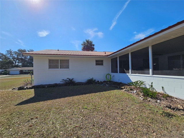 view of side of home with a yard