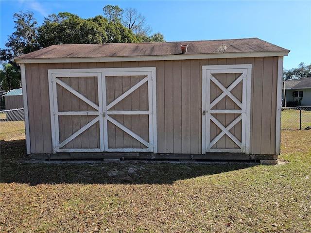 view of outbuilding featuring a yard