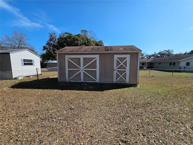 view of outbuilding featuring a lawn