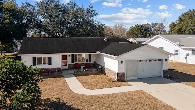 single story home with a garage, a front yard, and covered porch