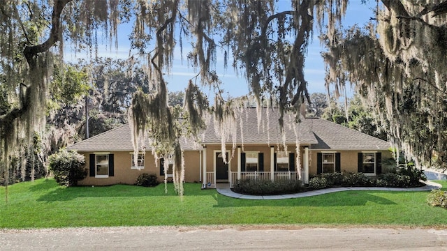 ranch-style house with a front yard and a porch