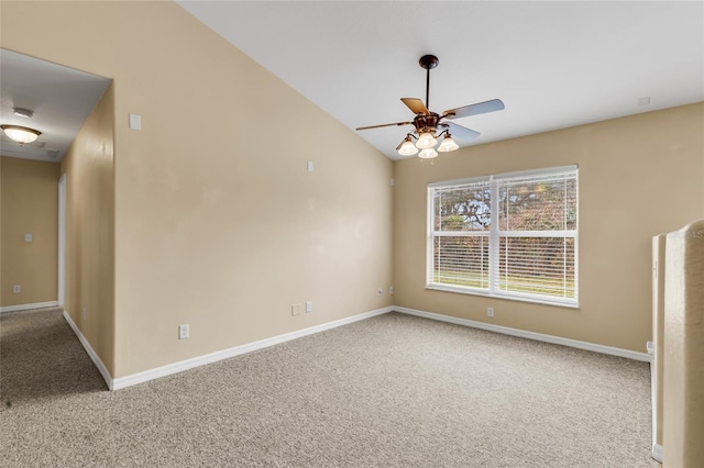 spare room with ceiling fan, lofted ceiling, and carpet floors