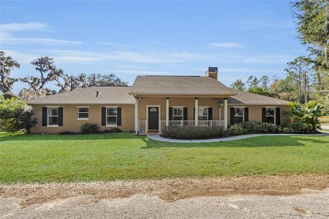 ranch-style house featuring a front lawn and covered porch