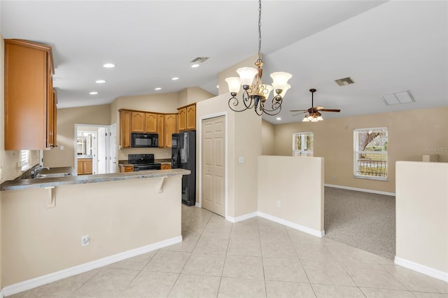 kitchen with light tile patterned flooring, black appliances, lofted ceiling, a kitchen breakfast bar, and kitchen peninsula