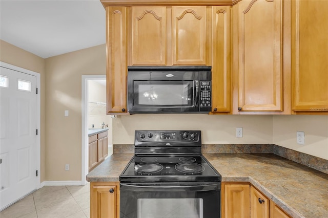 kitchen with light tile patterned floors and black appliances