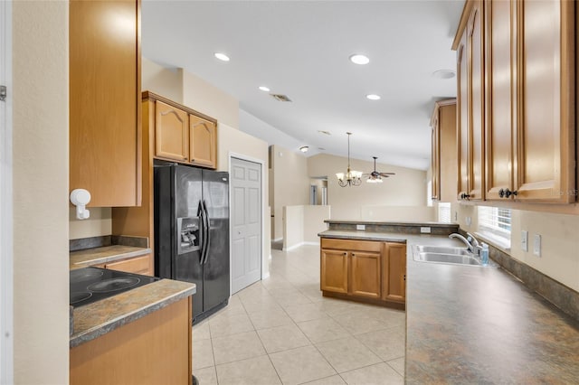 kitchen with vaulted ceiling, decorative light fixtures, black appliances, sink, and kitchen peninsula