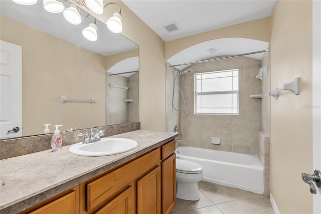 full bathroom with vanity, tile patterned floors, toilet, and tiled shower / bath