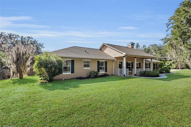 ranch-style house featuring a porch and a front yard