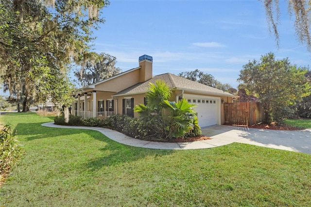 view of side of property with a yard and a garage