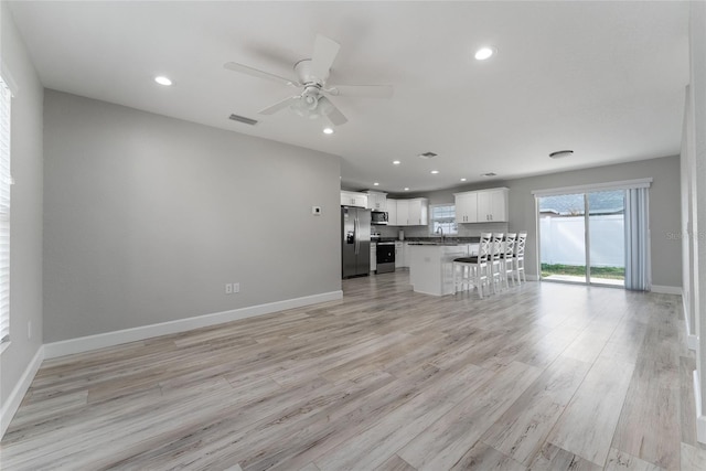 1302 NE 22nd Ave, Ocala, FL 34470 - unfurnished living room featuring ceiling fan and light hardwood / wood-style floors