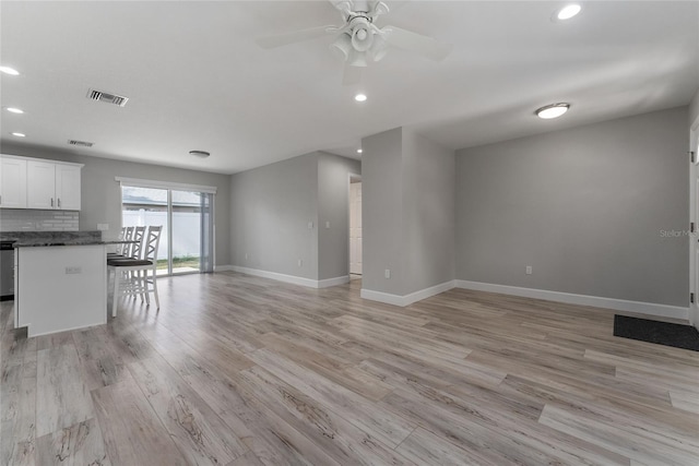 1302 NE 22nd Ave, Ocala, FL 34470 - unfurnished living room featuring ceiling fan and light wood-type flooring