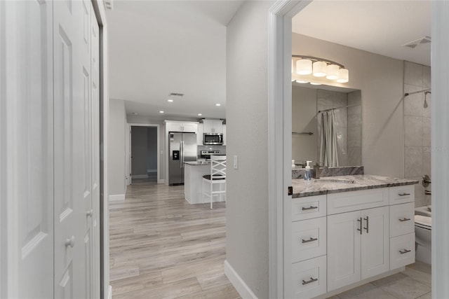 1302 NE 22nd Ave, Ocala, FL 34470 - full bathroom featuring vanity, wood-type flooring, shower / bath combo, and toilet