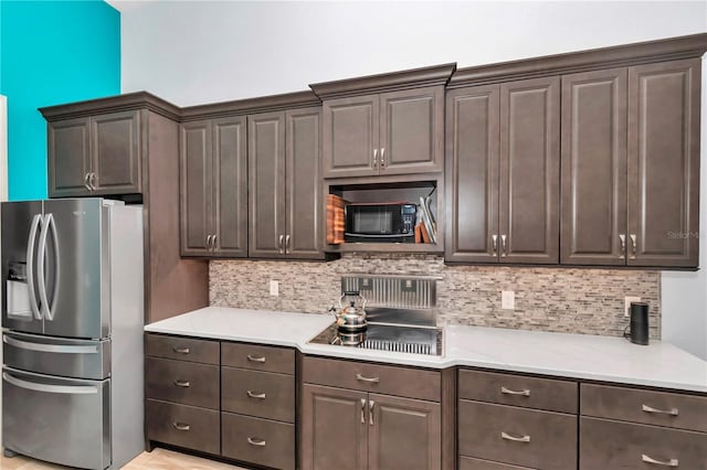 kitchen with tasteful backsplash, dark brown cabinetry, and black appliances