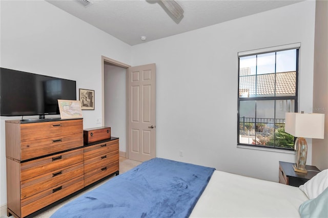 bedroom featuring ceiling fan and a textured ceiling