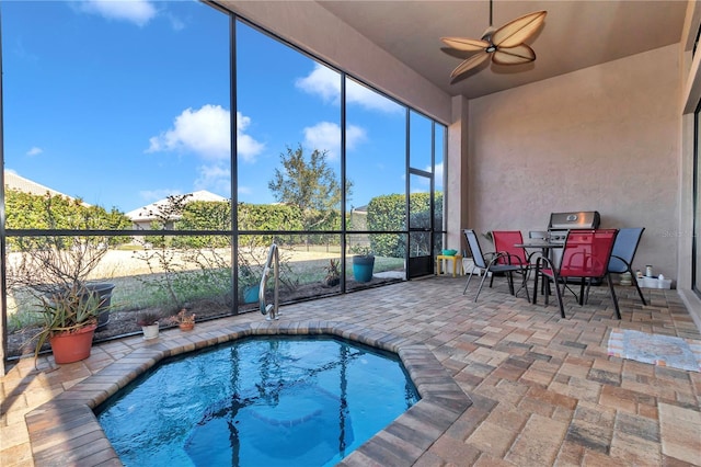 view of pool with ceiling fan and a jacuzzi