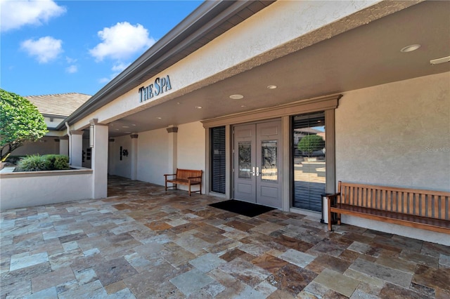 entrance to property featuring a patio area and french doors