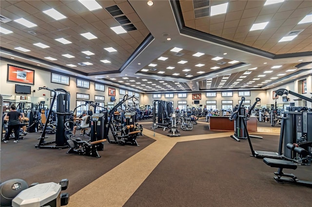 gym featuring ornamental molding and a drop ceiling