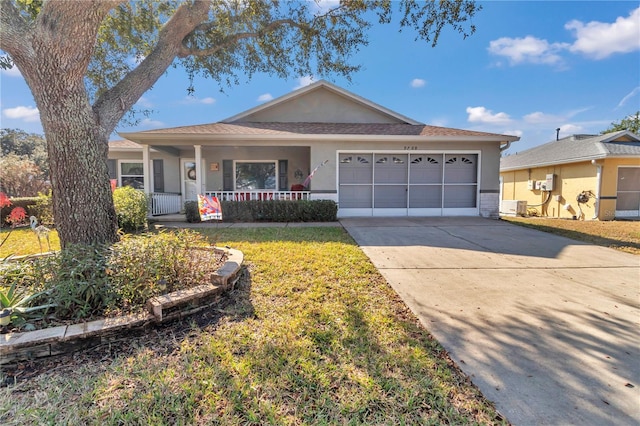 ranch-style home with a garage, covered porch, and a front lawn