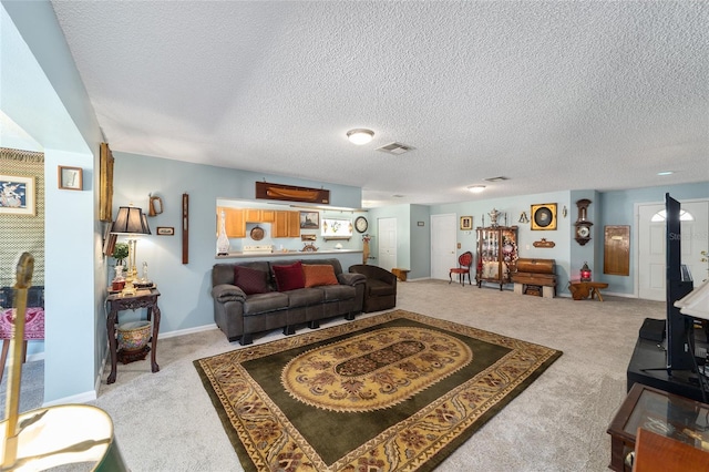 living room with light colored carpet and a textured ceiling