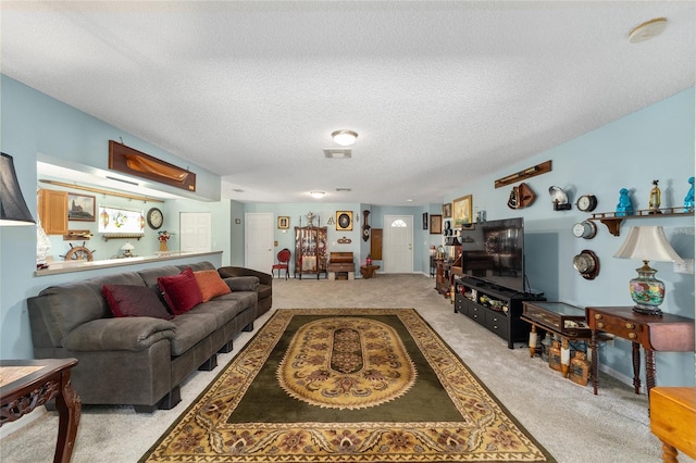 living room featuring light colored carpet and a textured ceiling