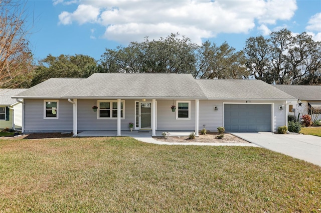 single story home with a garage, a front yard, and covered porch