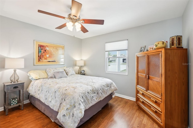 bedroom with hardwood / wood-style flooring and ceiling fan