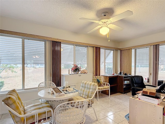 dining area featuring light tile patterned flooring, a textured ceiling, and ceiling fan