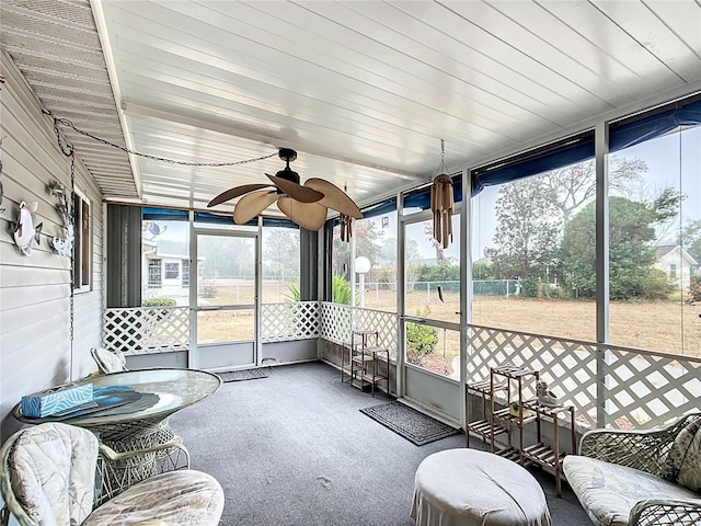 sunroom / solarium featuring ceiling fan