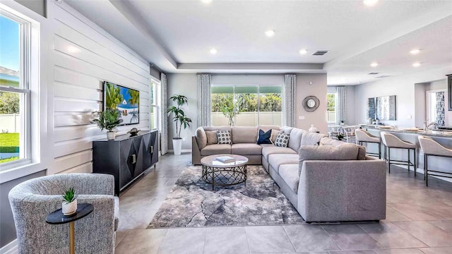 living room with a tray ceiling