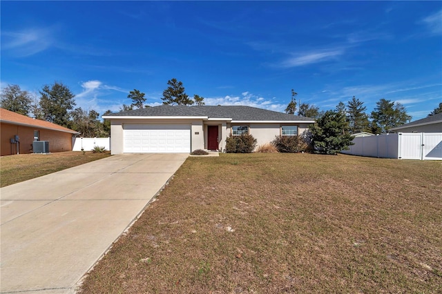 ranch-style home featuring a garage, central AC, and a front yard