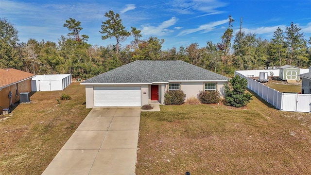 ranch-style home featuring a garage, a front lawn, and central air condition unit