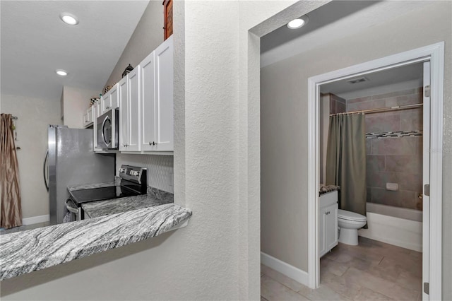 kitchen featuring light stone countertops, white cabinets, and appliances with stainless steel finishes