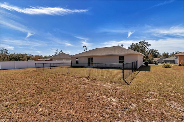 rear view of property with a lawn