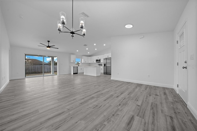 unfurnished living room featuring lofted ceiling, ceiling fan with notable chandelier, and light wood-type flooring