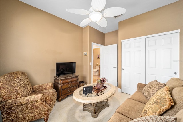 carpeted living room with ceiling fan