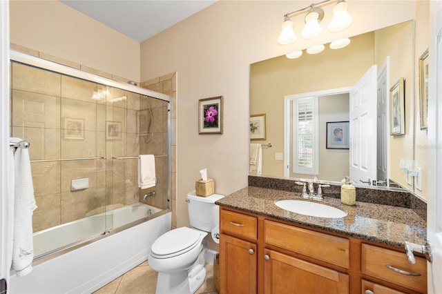 full bathroom with tile patterned flooring, vanity, shower / bath combination with glass door, and toilet