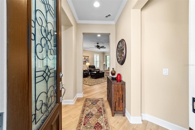 foyer featuring crown molding, ceiling fan, and light hardwood / wood-style flooring