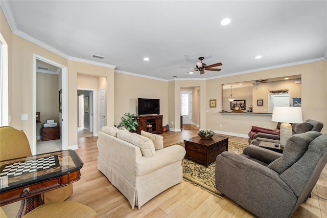 living room featuring light hardwood / wood-style flooring and ornamental molding