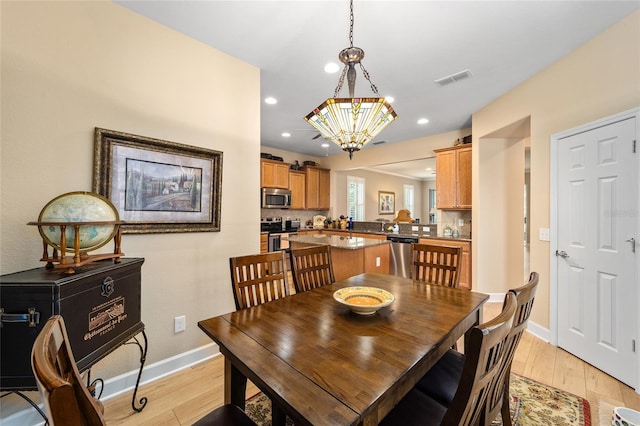 dining room with light hardwood / wood-style flooring