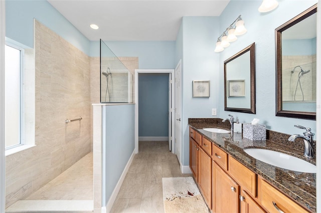 bathroom featuring vanity and tiled shower