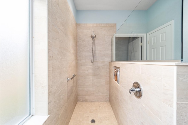 bathroom featuring a tile shower