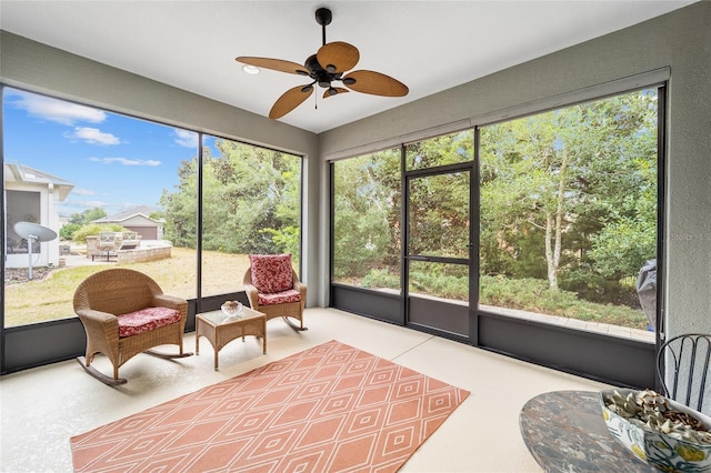 sunroom featuring ceiling fan and a healthy amount of sunlight