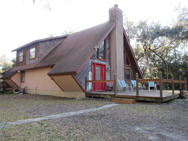 back of property featuring a deck