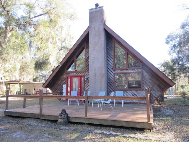 rear view of house featuring a wooden deck