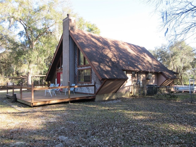 rear view of property with a yard and a deck