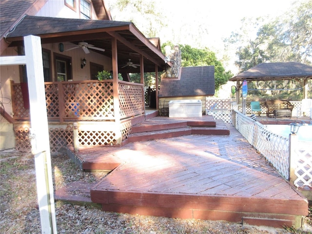 wooden deck with a gazebo and ceiling fan