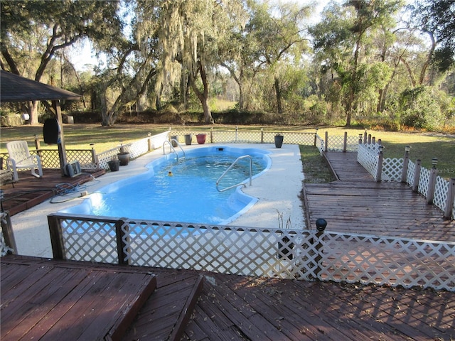 view of swimming pool with a wooden deck